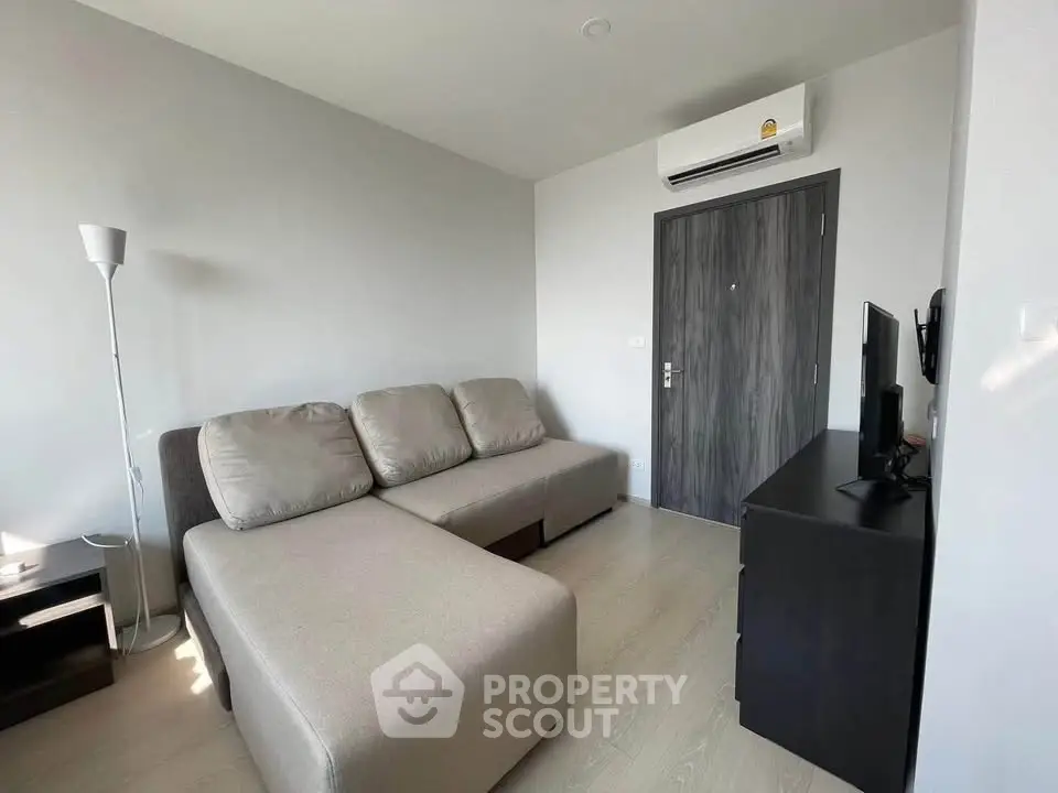 Modern living room with sleek furniture and air conditioning, perfect for comfortable urban living.