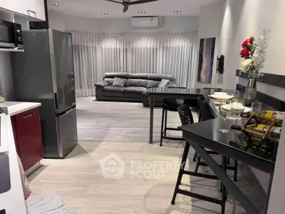 Modern open-plan living room with sleek kitchen and stylish decor