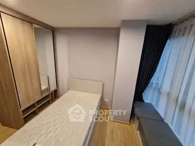 Cozy bedroom with minimalist design and large window for natural light