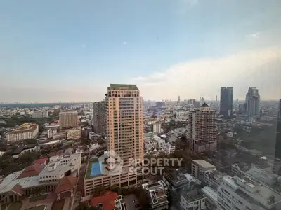 Stunning cityscape view from high-rise building showcasing urban skyline and residential towers.