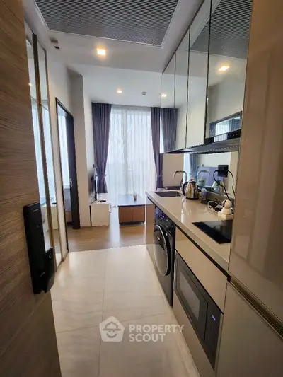 Modern kitchen with sleek appliances and open layout in stylish apartment