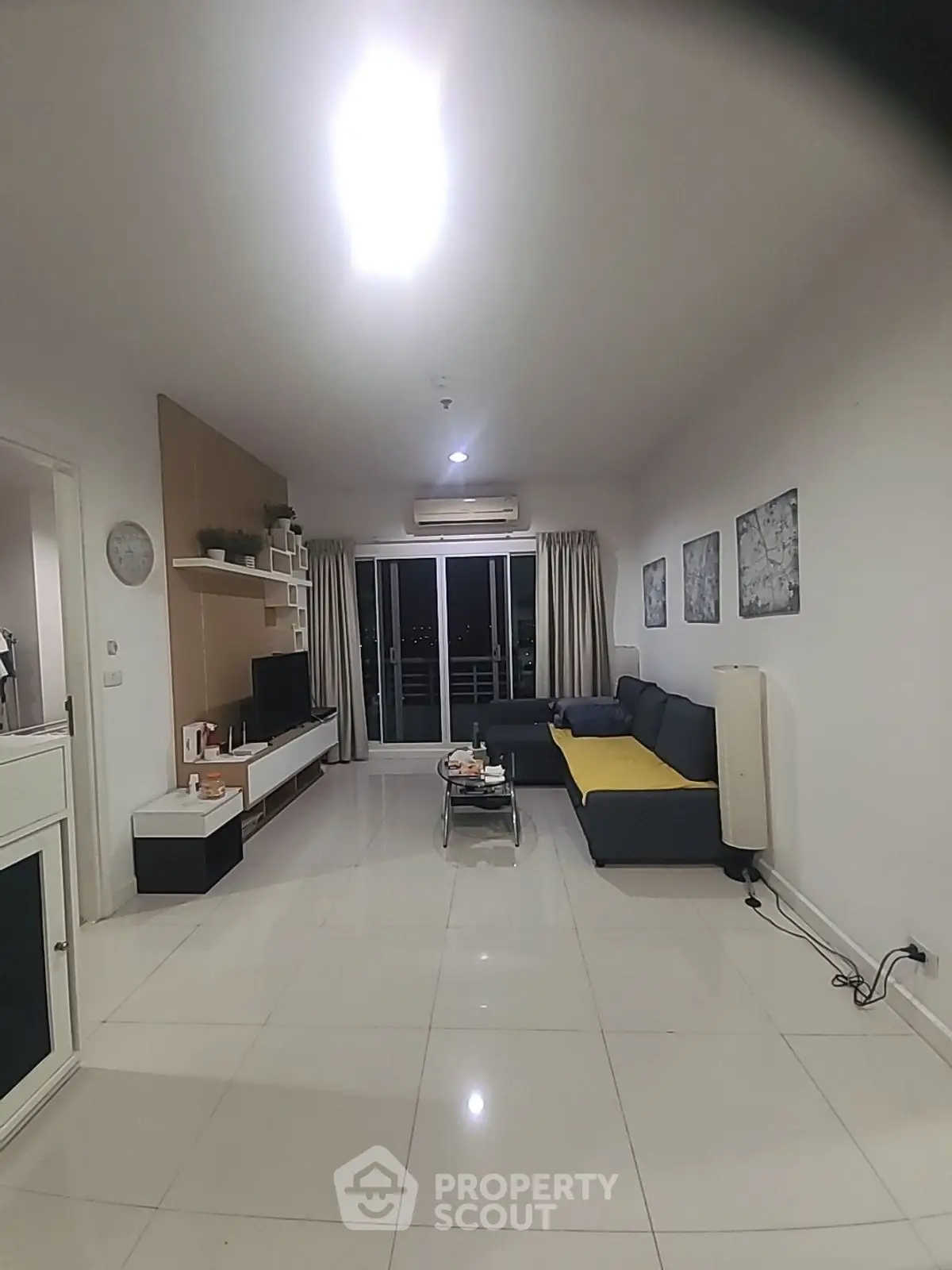 Spacious modern living room with sleek furniture and large windows for natural light.