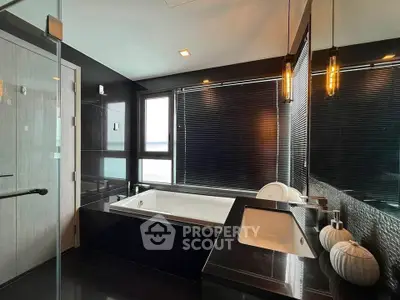 Luxurious modern bathroom with sleek black design and large bathtub