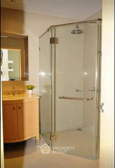Modern bathroom with glass shower and wooden vanity unit