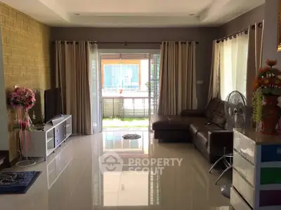 Spacious living room with modern decor and large windows for natural light.