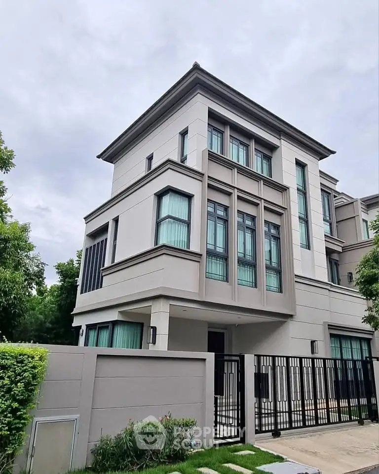 Luxurious modern townhouse with sleek design and large windows in a serene neighborhood.