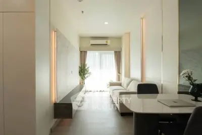 Modern living room with sleek design and natural light, featuring a cozy sofa and elegant dining area.