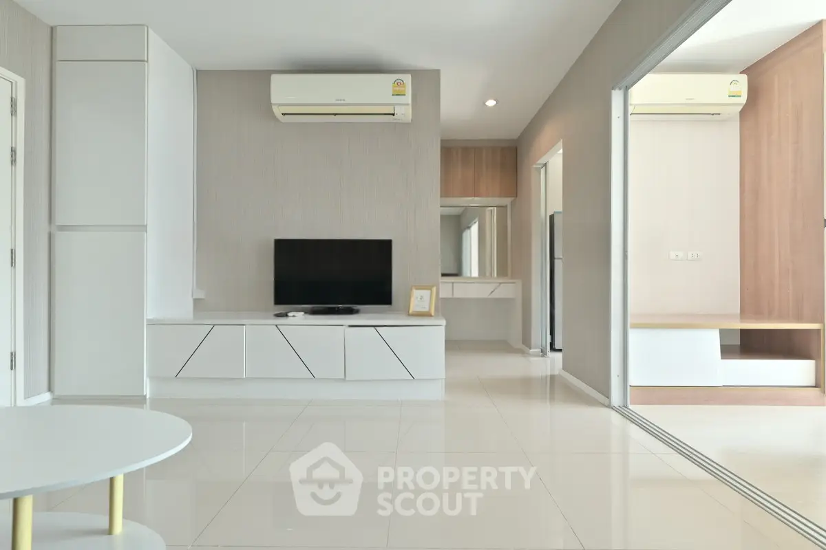 Modern living room with sleek design, air conditioning, and minimalist furniture in a bright apartment.