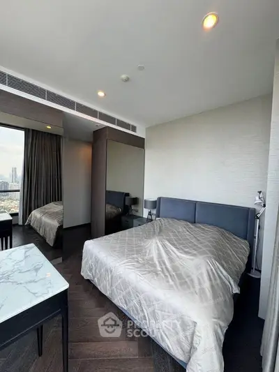 Modern bedroom with city view, featuring sleek furniture and elegant decor.
