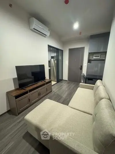 Modern living room with sleek furniture and air conditioning in a cozy apartment.