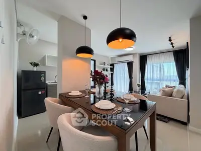 Modern open-plan living and dining area with stylish lighting and contemporary decor.