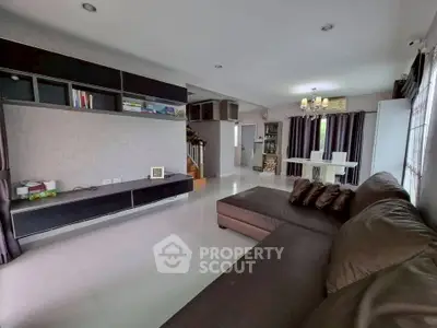 Spacious modern living room with sleek furniture and open layout, perfect for family gatherings.
