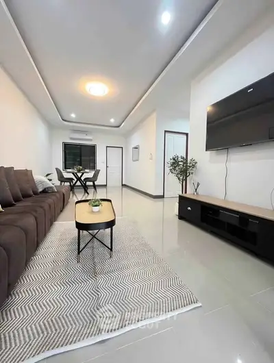 Modern living room with sleek design and large TV, perfect for relaxation.