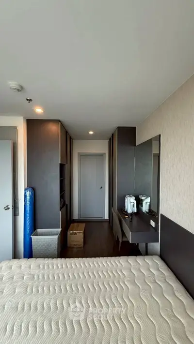 Modern bedroom with sleek design and ample storage in a high-rise apartment.