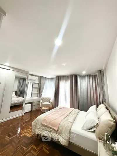 Spacious bedroom with elegant decor and natural light