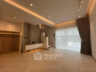 Spacious modern living room with elegant lighting and large windows