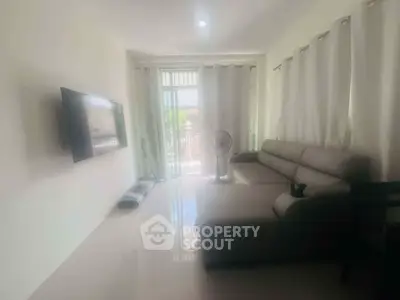 Modern living room with sleek furniture and large window for natural light.