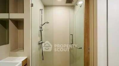 Modern bathroom with glass shower enclosure and sleek fixtures