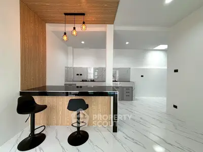 Modern kitchen with sleek design, open layout, and stylish lighting in a contemporary home.