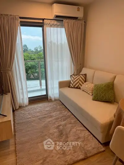 Cozy living room with a view, featuring a comfortable sofa and elegant decor.