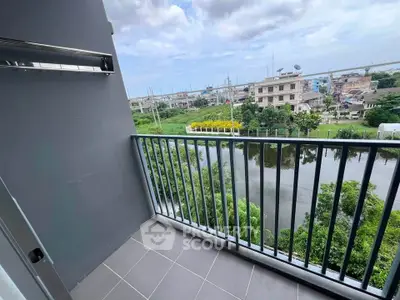 Spacious balcony with serene water view in modern apartment