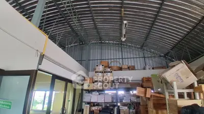 Spacious storage area with high ceiling and organized shelving
