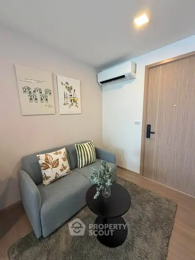 Cozy living room with modern decor and air conditioning in a stylish apartment.