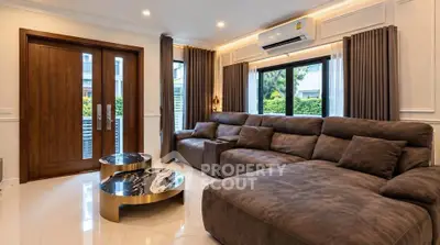 Luxurious living room with plush sectional sofa and elegant marble coffee tables.
