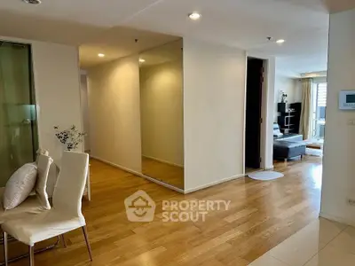 Spacious modern living area with wooden flooring and elegant decor