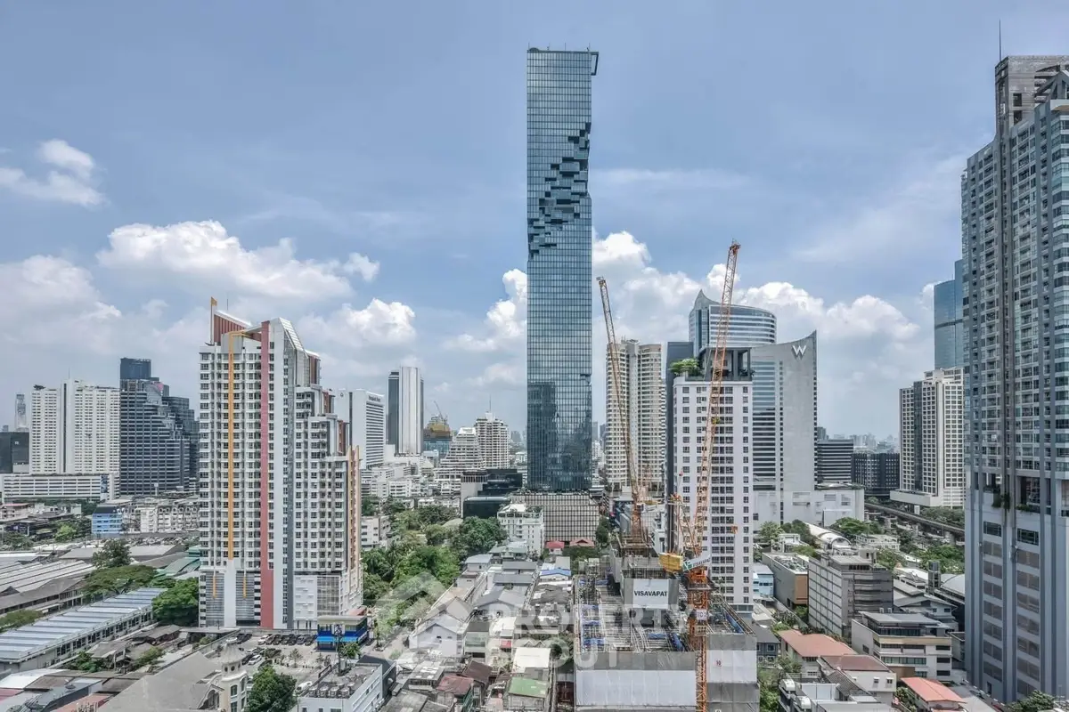 Stunning cityscape view featuring modern skyscrapers and construction cranes in a bustling urban environment.