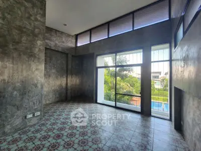 Spacious modern living room with large windows and garden view