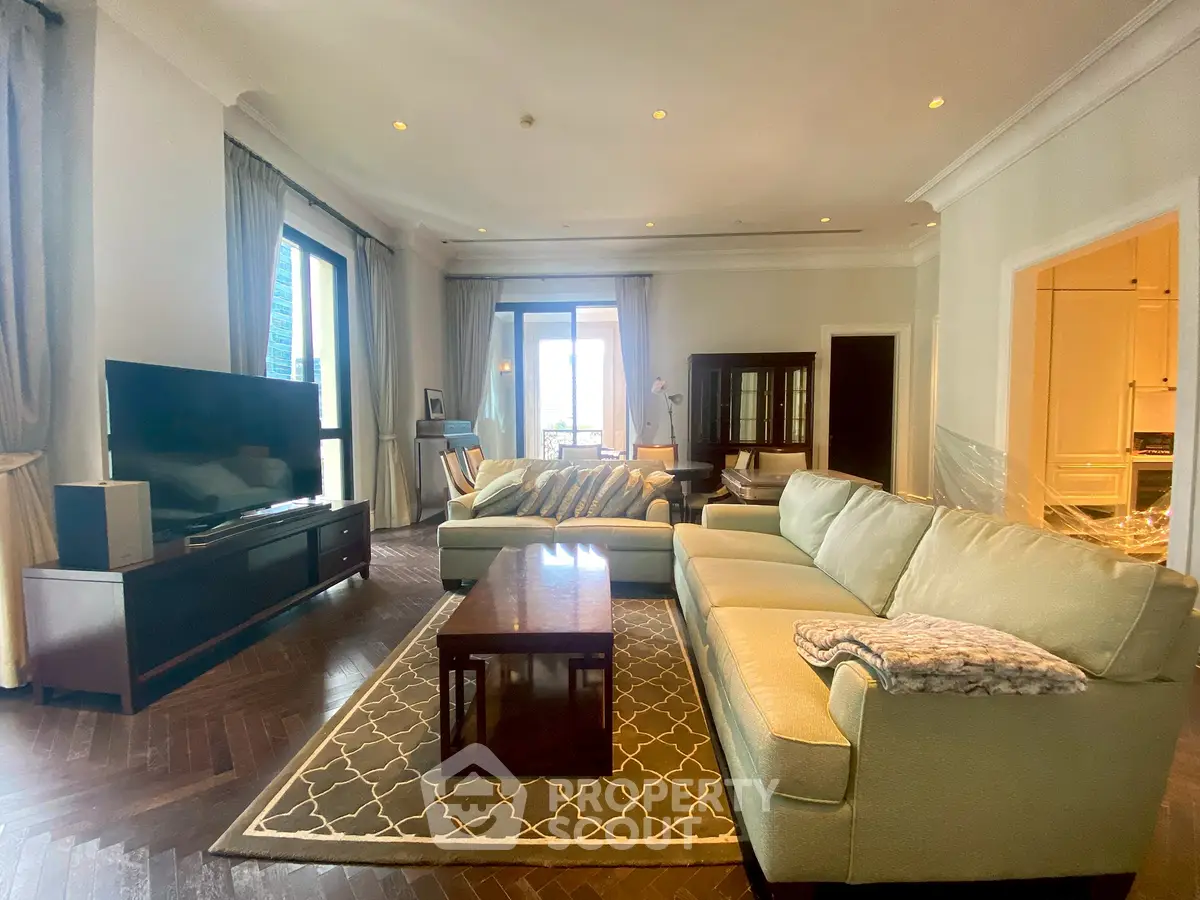 Luxurious living room with elegant furniture and large windows offering natural light.