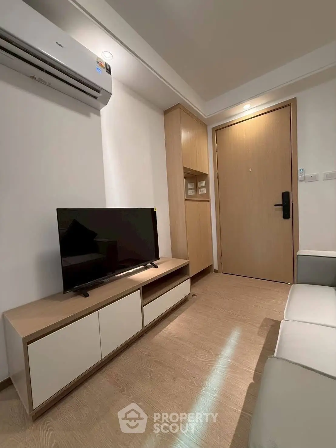 Modern living room with sleek furniture and air conditioning in a cozy apartment.