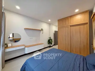 Modern bedroom with wooden wardrobe and stylish decor