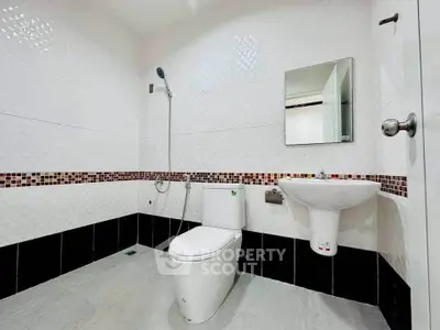 Modern bathroom with sleek white fixtures and stylish tile accents