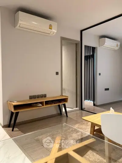 Modern living room with sleek air conditioning and stylish wooden furniture.