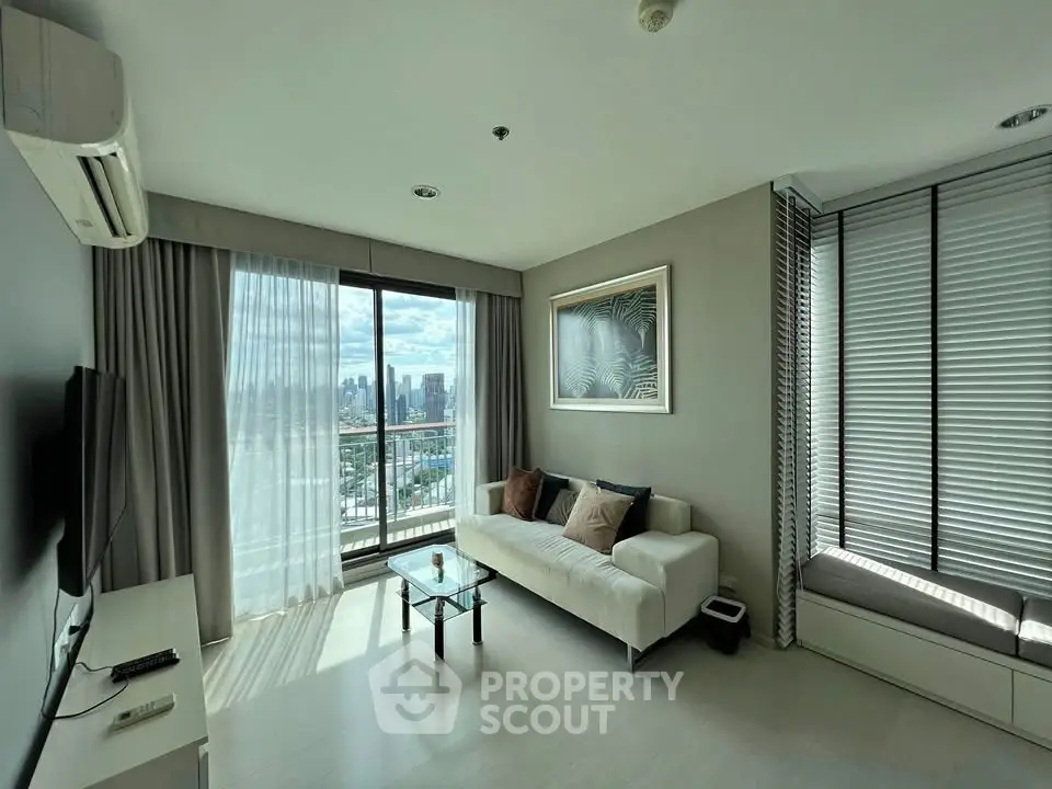 Modern living room with city view, large windows, and stylish decor in a high-rise apartment.