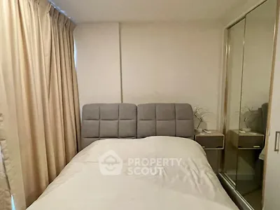 Cozy bedroom with mirrored wardrobe and neutral curtains