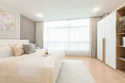 Luxurious bedroom with elegant decor and ample natural light