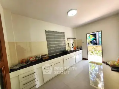 Spacious kitchen with sleek cabinetry and ample natural light
