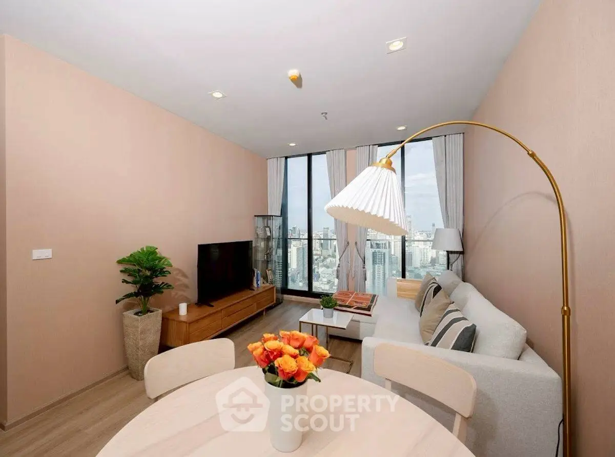Stylish modern living room with city view, elegant decor, and cozy ambiance.