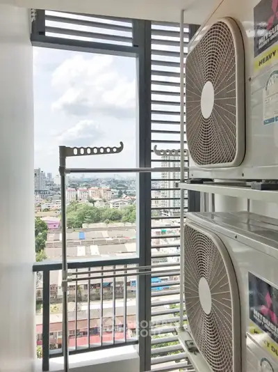 High-rise balcony with city view and air conditioning units, perfect for urban living.