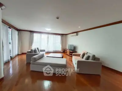 Spacious living room with elegant hardwood floors and modern furniture