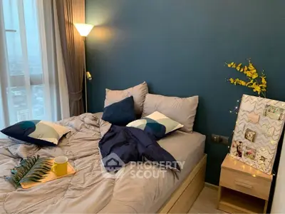 Cozy bedroom with modern decor and city view, featuring a stylish bed and ambient lighting.