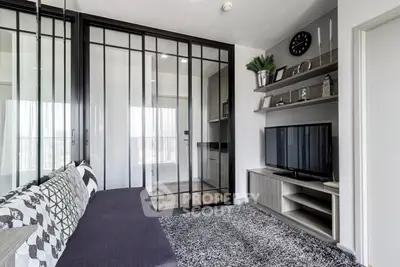 Modern living room with sleek glass doors and stylish decor