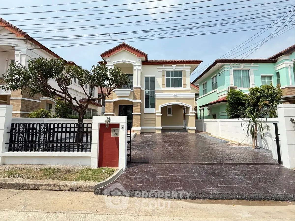 Charming two-story house with spacious driveway and modern exterior design.