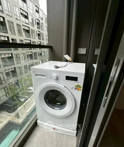 Modern apartment balcony with washing machine and city view