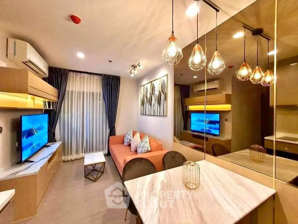 Modern living room with stylish lighting and cozy seating area in a contemporary apartment.