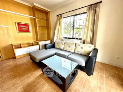 Stylish living room with modern sofa and glass coffee table, perfect for relaxation.