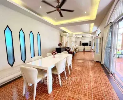 Spacious dining area with elegant decor and modern lighting, perfect for entertaining guests.